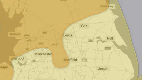 Met Office A map of northern England showing an amber area stretching across North and West Yorkshire and Lancashire. The rest of the map is yellow, indicating less severe weather.