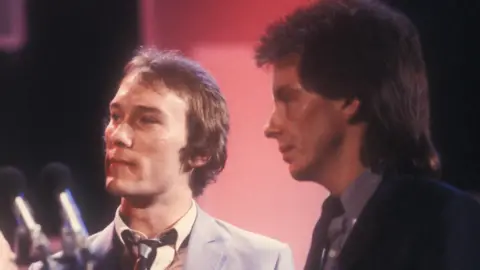 BBC Rick Buckler and Bruce Foxton, wearing suits and ties