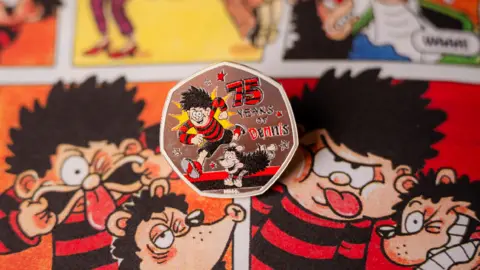 PA Media The new Dennis the Menace coin on one of the comic strips