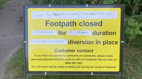 Brian Farmer/BBC Yellow sign saying footpath closed