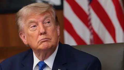 President Donald Trump listens to questions from reporters during a Cabinet meeting at Camp David, the presidential retreat, on July 31, 2026 in Camp David, Maryland. 