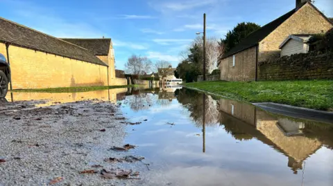 Reflected puddles of flooding in Greatford, Lincolnshire in January 2024