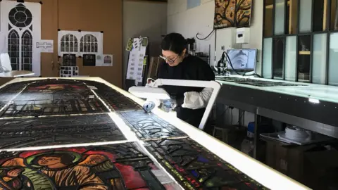 Flavie Vincent-Petit works on a stained glass window in Troyes