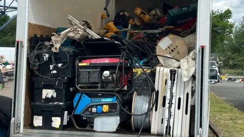 A van containing a large quantity of power tools.