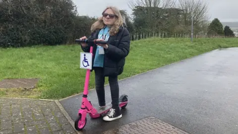 BBC Ella Wakley on her scooter