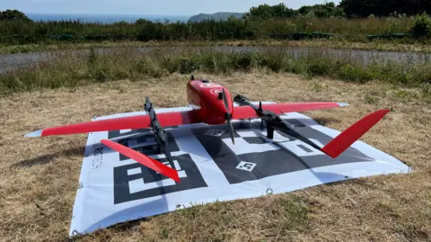 red drone on grass 