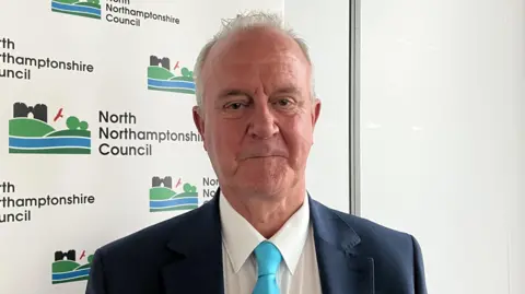 Nadia Lincoln A head and shoulders image of Martin Griffiths. He is wearing a navy suit jacket over a white shirt with a light blue tie. He is looking directly into the camera.
