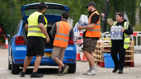 Water bottles are handed out at the Weald Sports Centre