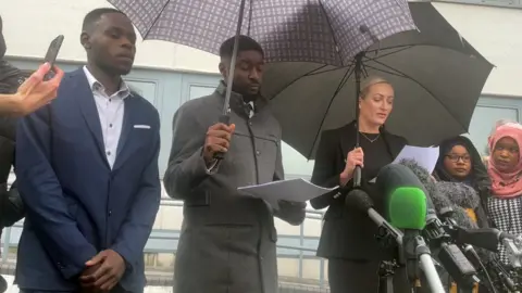 PA Media Awaab Ishak's father Faisal Abdullah, counsel for the family Christian Weaver, solicitor Kelly Darlington and Awaab's mother Aisha Amin (second right)