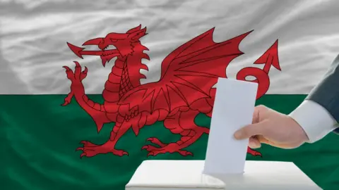 Ballot box with Wales flag behind