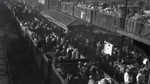 ICRC / HANDOUT Korean refugees are aboard a train at a station in South Korea"s southeastern city of Daegu amid the Korean War, on 29 December 1950