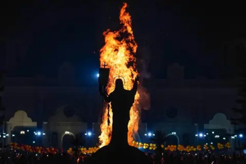 Getty Images Bonfire next to statue