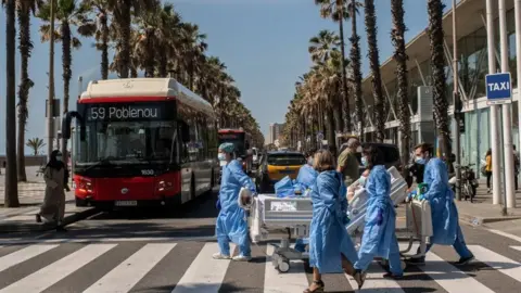 Getty Images Doctors in Barcelona take coronavirus patients to the beach