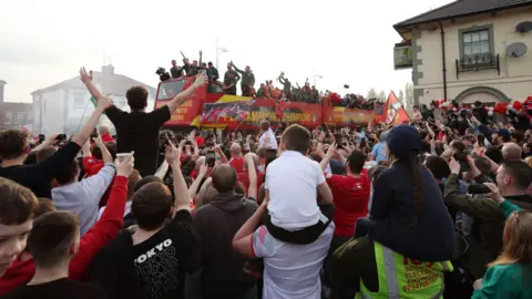 Getty Images Children sat on shoulders to get a glimpse of their favourite Wrexham players as they went past