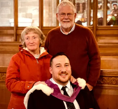 Jess Paul Neil Russell with his parents Ken and Hilary