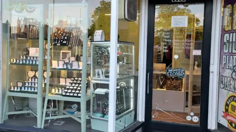 Google The storefront of Estcourt Jewellers. There are large windows showing displays of rings, necklaces, bracelets and earrings.