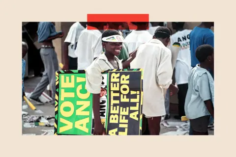 Getty Images A 1994 photo of a boy carrying an ANC election placard