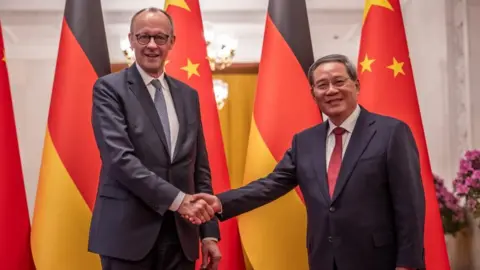 EPA Chancellor of Germany Friedrich Merz (L) and Premier of China Li Qiang shake hands at the Great Hall of the People in Beijing, China