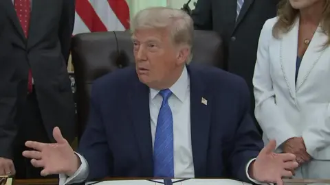 Trump at his Oval Office desk