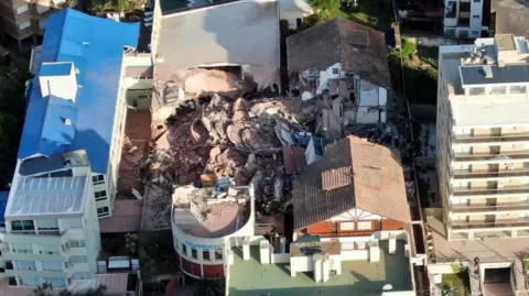 Reuters / Pablo Funes Drone footage from above shows the destroyed Dubrovnik hotel in the coastal town of Villa Gesell - piles of rubble seen