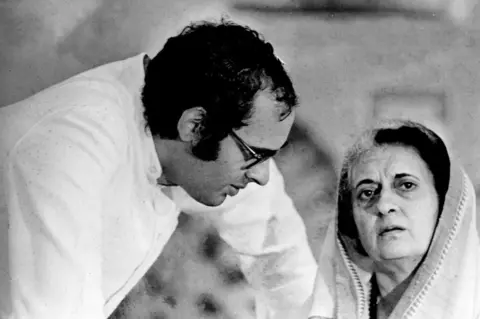 Sondeep Shankar/Getty Images Prime Minister Indira Gandhi (1917 - 1984) with son Sanjay Gandhi during the Guwahati, Assam session of the All India Congress Committee November 19, 1976. (Photo by Sondeep Shankar/Getty Images)