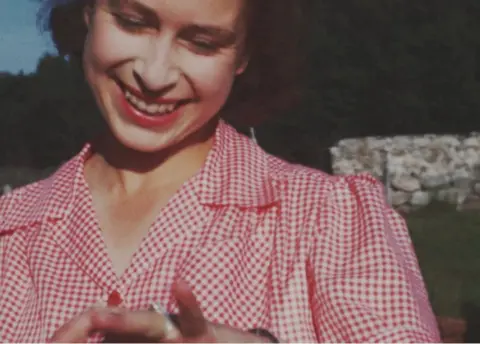 BBC The then Princess Elizabeth showing off her new engagement ring soon after Prince Philip's marriage proposal