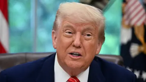 US President Donald Trump makes a trade announcement in the Oval Office of the White House in Washington, DC, on 8 May.