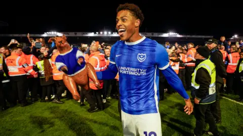 Kusini Yengi celebrates as Portsmouth win promotion at Fratton Park