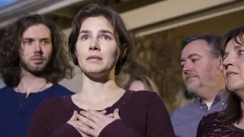 Getty Images Amanda Knox speaking at a press conference with her family after she was acquitted of murder in 2015