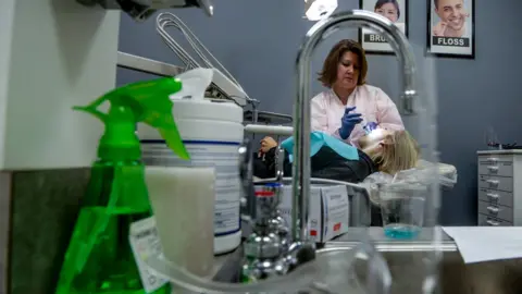 BBC Dentist cleans patients teeth