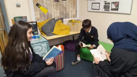 Three students at Kings Road Primary studying