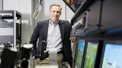 Getty Images Kelly Ortberg stands by a row of computers at the Rockwell Collins production facility in 2016