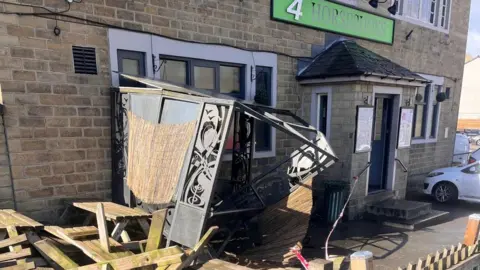 Danny Black The ruins of a smoking shelter outside a pub after it was hit by a car