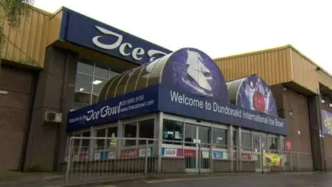 Exterior of dundonald ice bowl, a brown brick building with purple signage