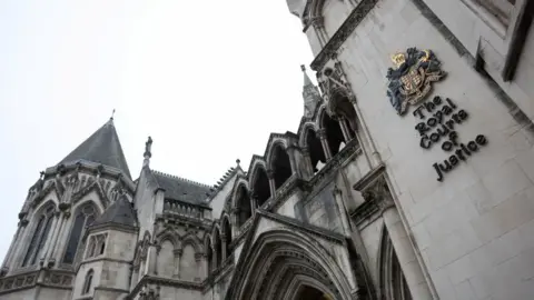 Reuters Part of the Royal Courts of Justice: an ornate grey building with the words "The Royal Courts of Justice" written in black on the side.