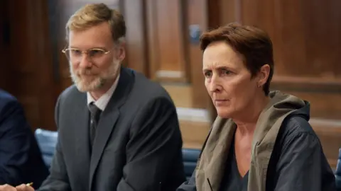 Sid Gentle Films/Robert Viglasky L to R: Frank Haleton (DARREN BOYD), Carolyn Martens (FIONA SHAW)