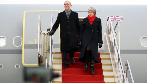 Getty Images Theresa May and husband Philip arrive at Wuhan airport on 31 January 2018