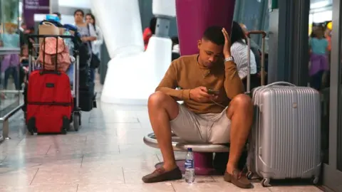 AFP Delayed traveller at Heathrow