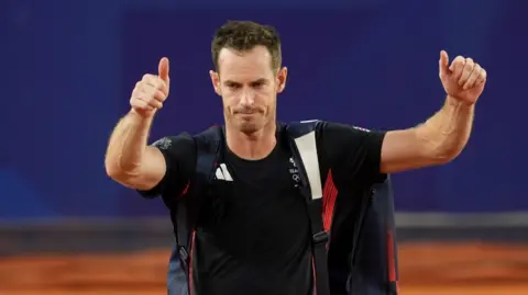 PA Media Andy Murray acknowledges the crowd after his defeat in the men's doubles