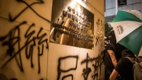 Getty Images Protesters spray graffiti on the walls of the Chinese government's liaison office in Hong Kong after taking part in an anti-extradition bill march on July 21, 2019