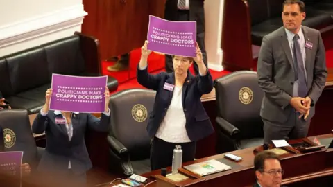 Reuters Democratic lawmakers protest after North Carolina Republican lawmakers vote to override Democratic Governor Roy Cooper's veto on 16 May 2023