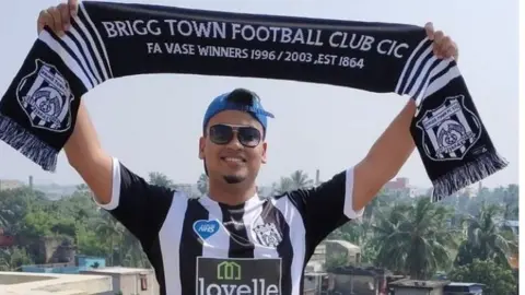 Rohan Chowdhury Rohan Chowdhury with a Brigg Town scarf