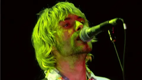 Getty Images Nirvana's lead singer and songwriter Kurt Cobain on stage at the Reading Festival on 30 August 1992