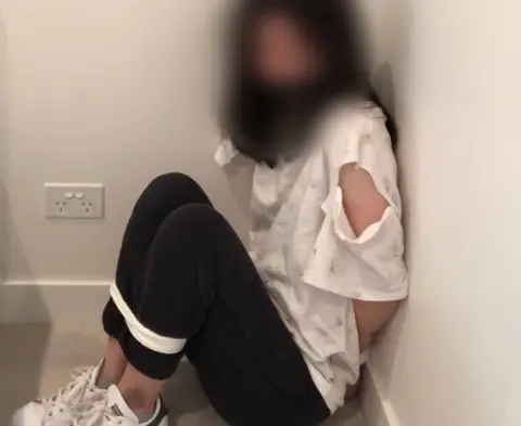 NSW POLICE Police-supplied image of a woman wearing a ripped shirt bound in a staged kidnap