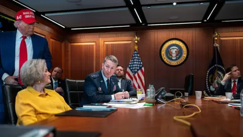 US President Donald Trump, Chief of Staff of the White House Susi Wilz, Chairman of the Joint Chief of Staff Dan Kane, Vice President J. D. Vens and Secretary of State Mark Rubio sit indoors when they monitor the mission that brought out three Iranian nuclear enrichment sites.