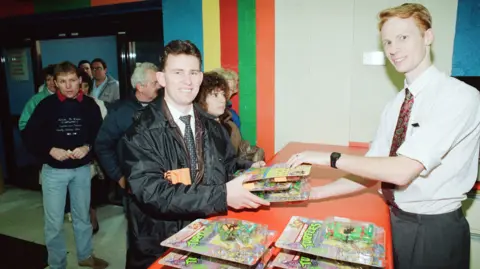 Mirrorpix/Contributor Shoppers, sporting perms and light-coloured jeans, form a queue at Toys R Us in Stockton in November 1990 to buy Teenage Mutant Ninja Turtles figures.