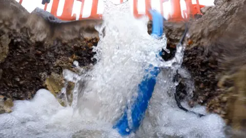 BBC Water gushing out of a burst pipe