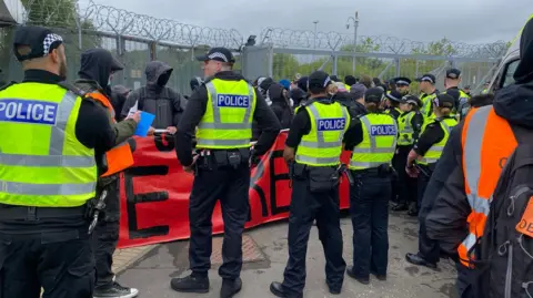Police and protesters outside the Thales factory