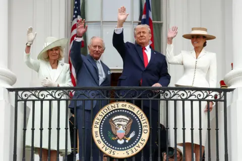 Reuters The Queen, King, Donald and Melania Trump all wave in formal attire with a plaque that says 'Seal of the president of the United States' as they stand on the balcony of the White House on Tuesday.