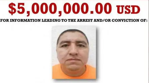 US Department of State via Reuters A screengrab of a Wanted poster shows a mugshot of Flores wearing an orange T-shirt. The text above his photo reads: $5,000,000.00 USD for information leading to the arrest and/or conviction of: